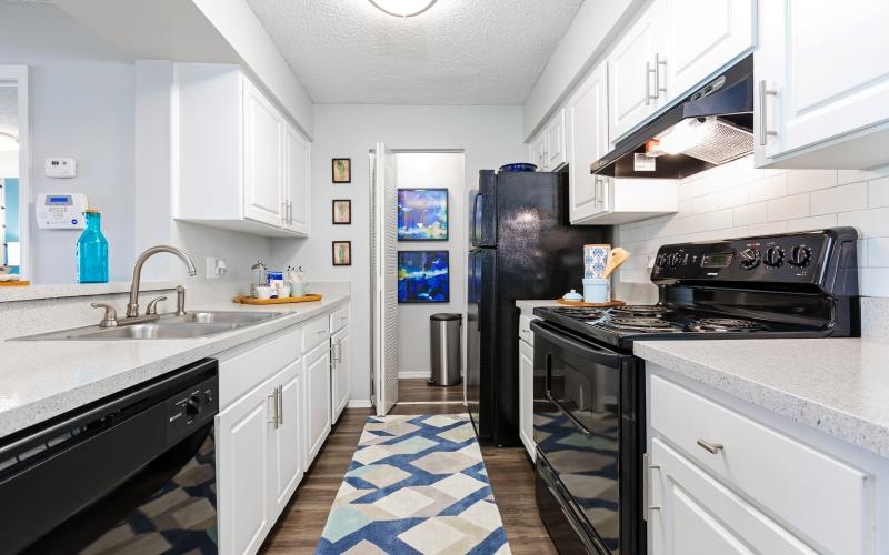 a kitchen with white cabinets