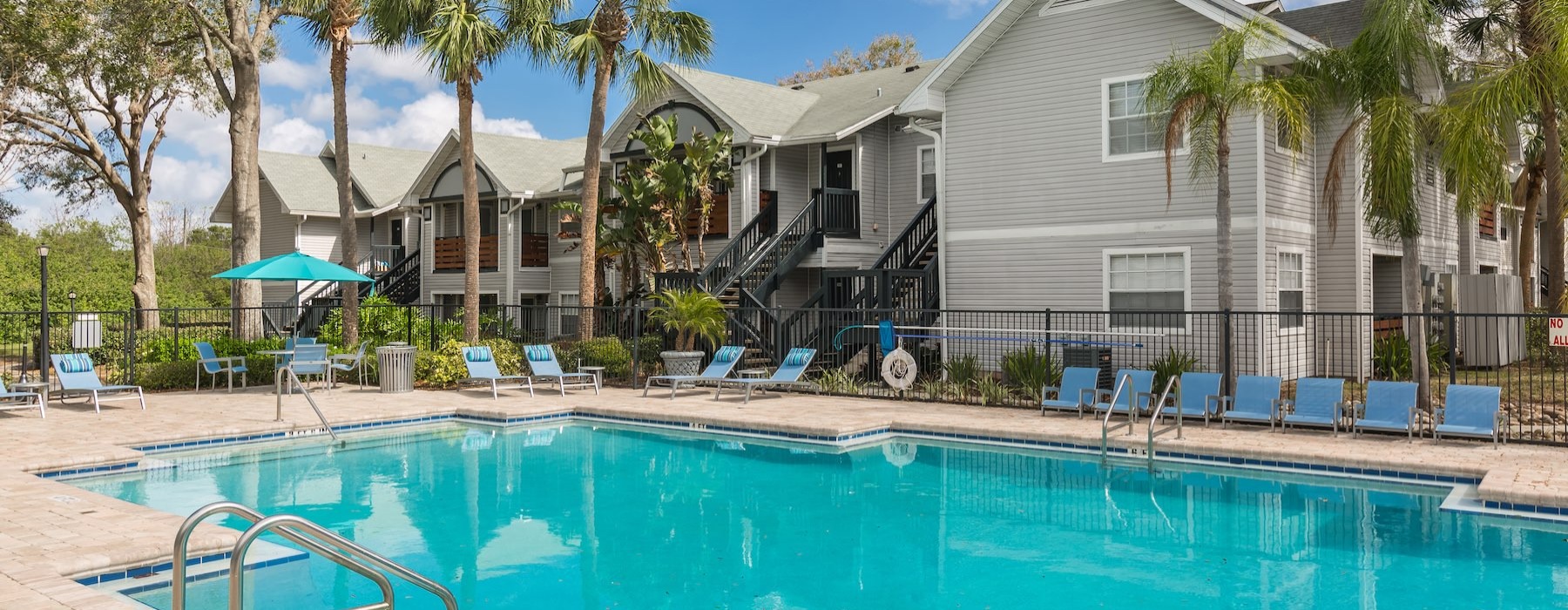 a swimming pool with a house in the background